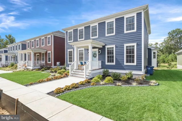 a front view of a house with a yard and porch