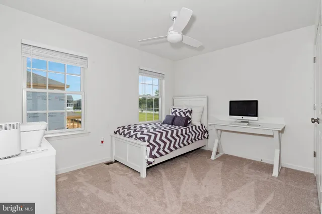 a bedroom with a bed dresser and a window