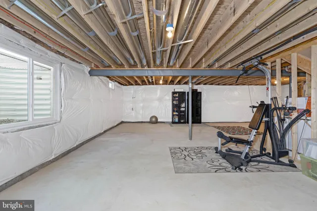 a view of empty room with wooden ceiling