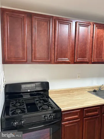 a stove top oven sitting inside of a kitchen