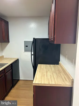 a view of an empty room with closet and a window