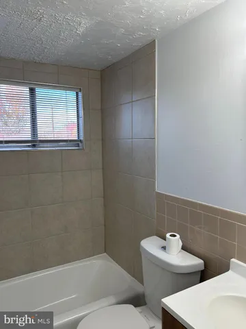 a bathroom with a window and a shower