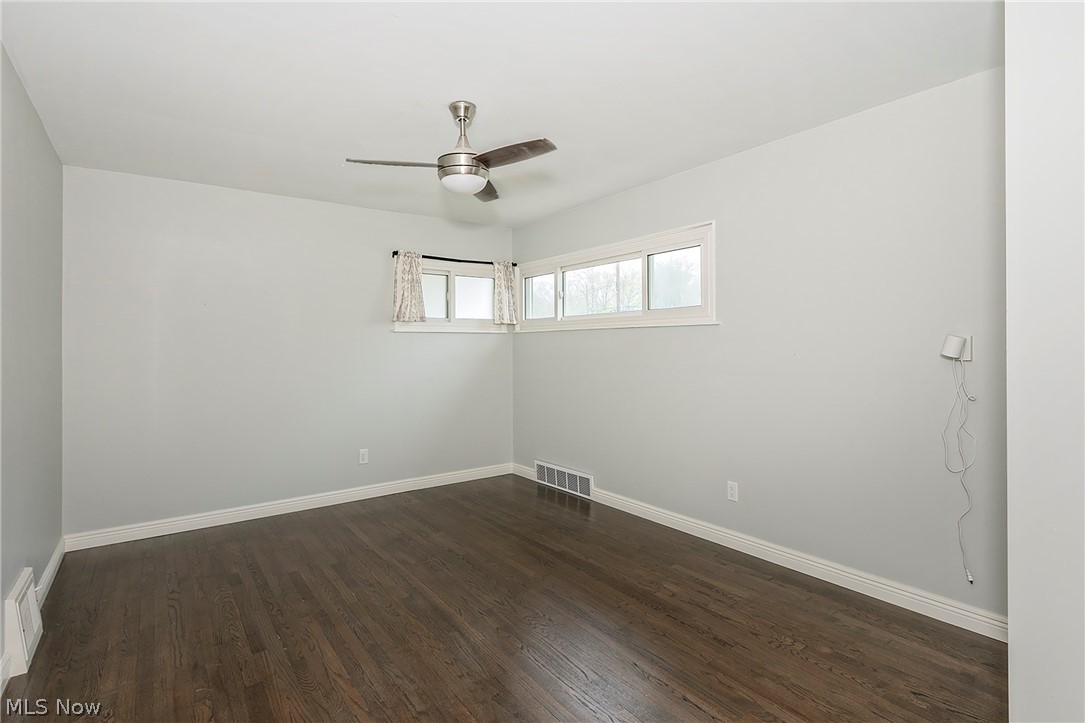 3719 Walter Road North Olmsted, OH 44070 - Photo 16 of 35 Spacious room featuring dark wood-finish flooring, white baseboards, and light gray walls