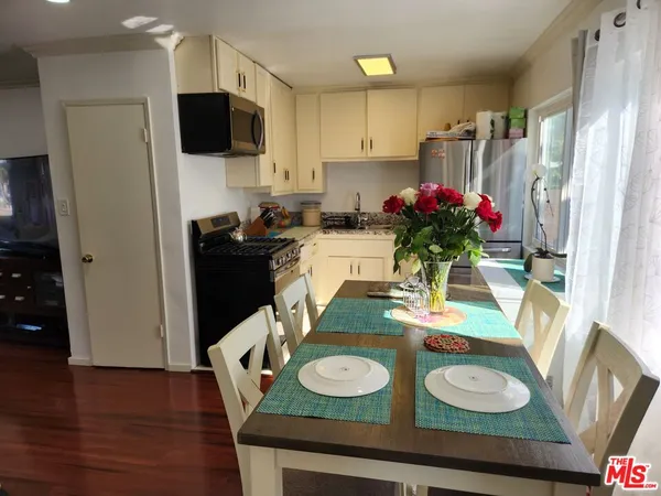 a kitchen with a table and chairs in it