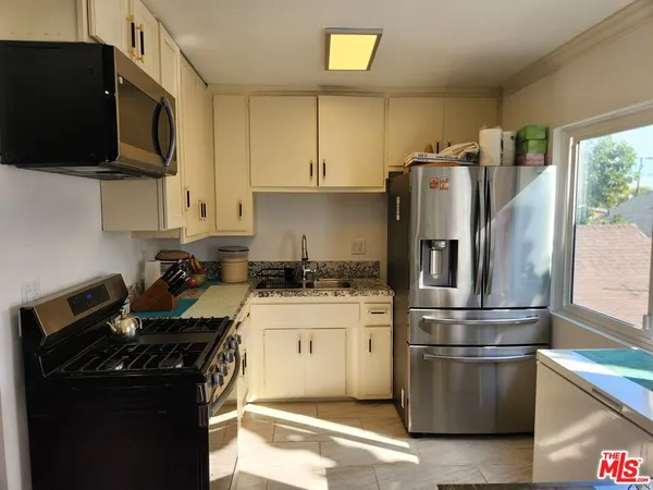 a kitchen with a stove and a refrigerator