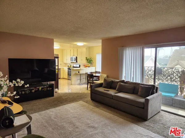 a kitchen with a sink refrigerator and microwave