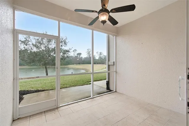 a view of kitchen with stainless steel appliances granite countertop white cabinets and window