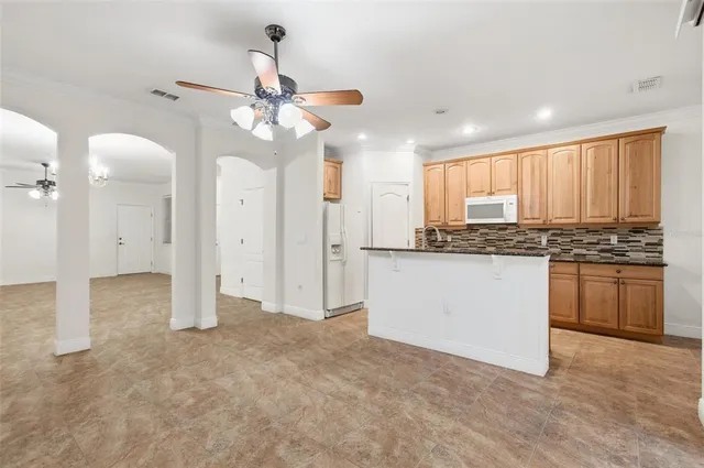 a kitchen with stainless steel appliances granite countertop a sink and cabinets