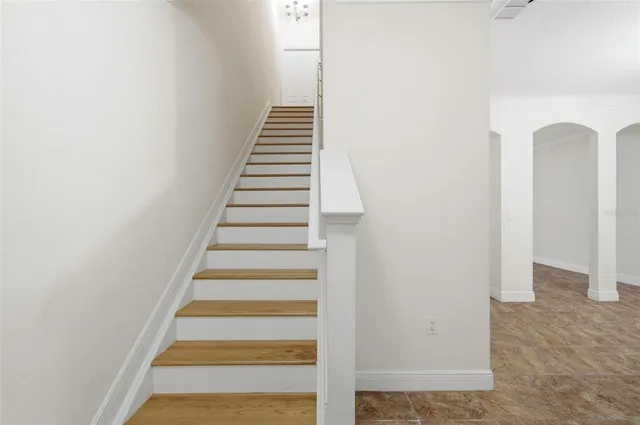 an empty room with a window and a ceiling fan