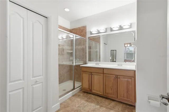 a bathroom with a double vanity sink and mirror