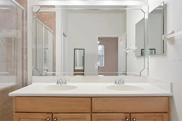 an empty room with wooden floor cabinet and windows