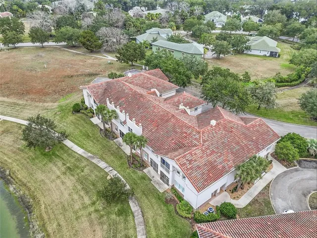 an aerial view of residential houses with outdoor space and swimming pool