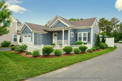 a view of a house with a small yard and plants