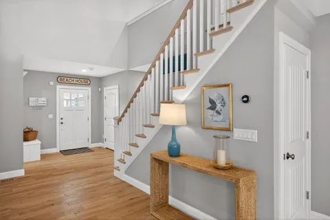 a view of entryway and hall with wooden floor