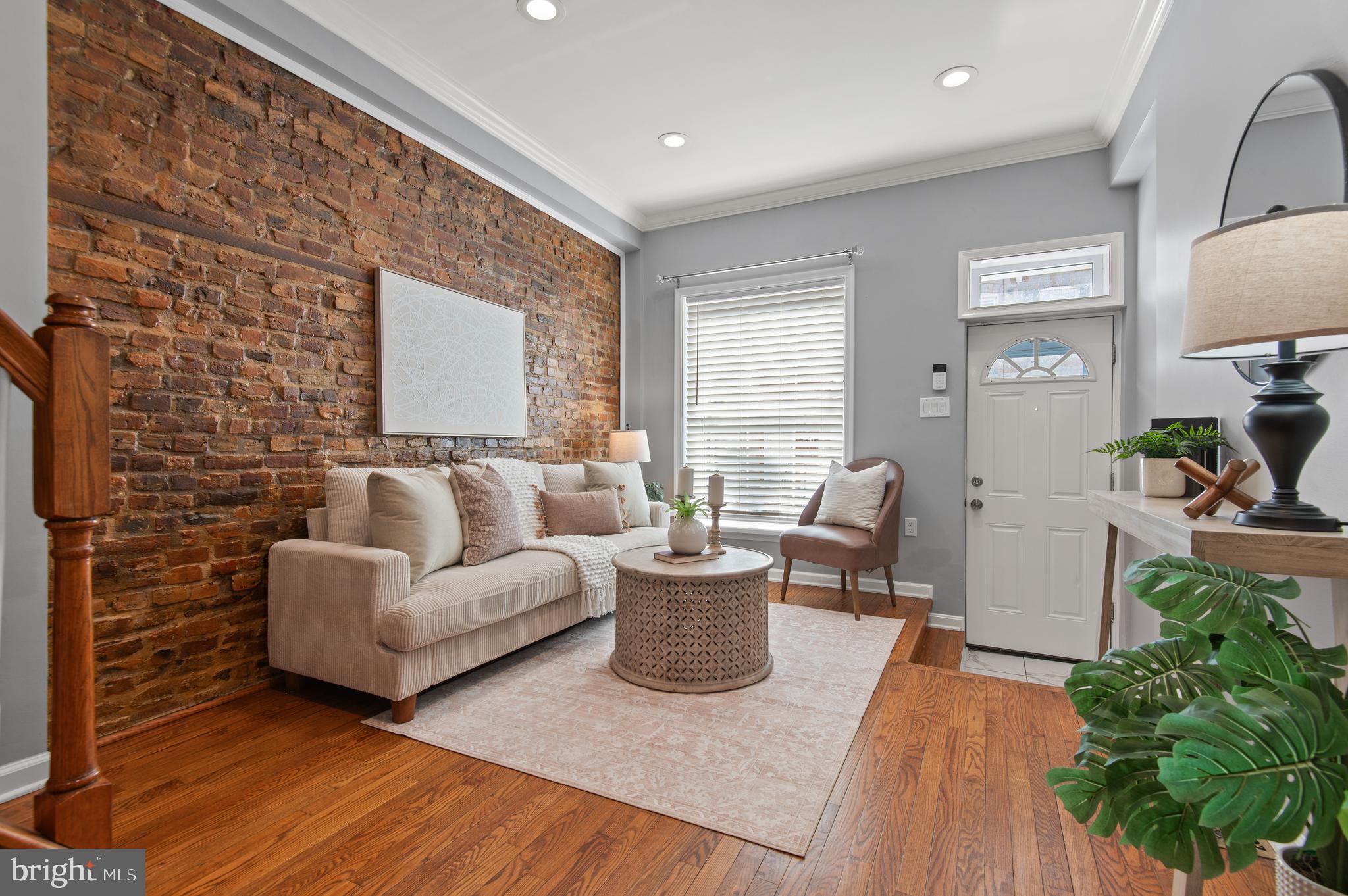 a living room with furniture and a potted plant