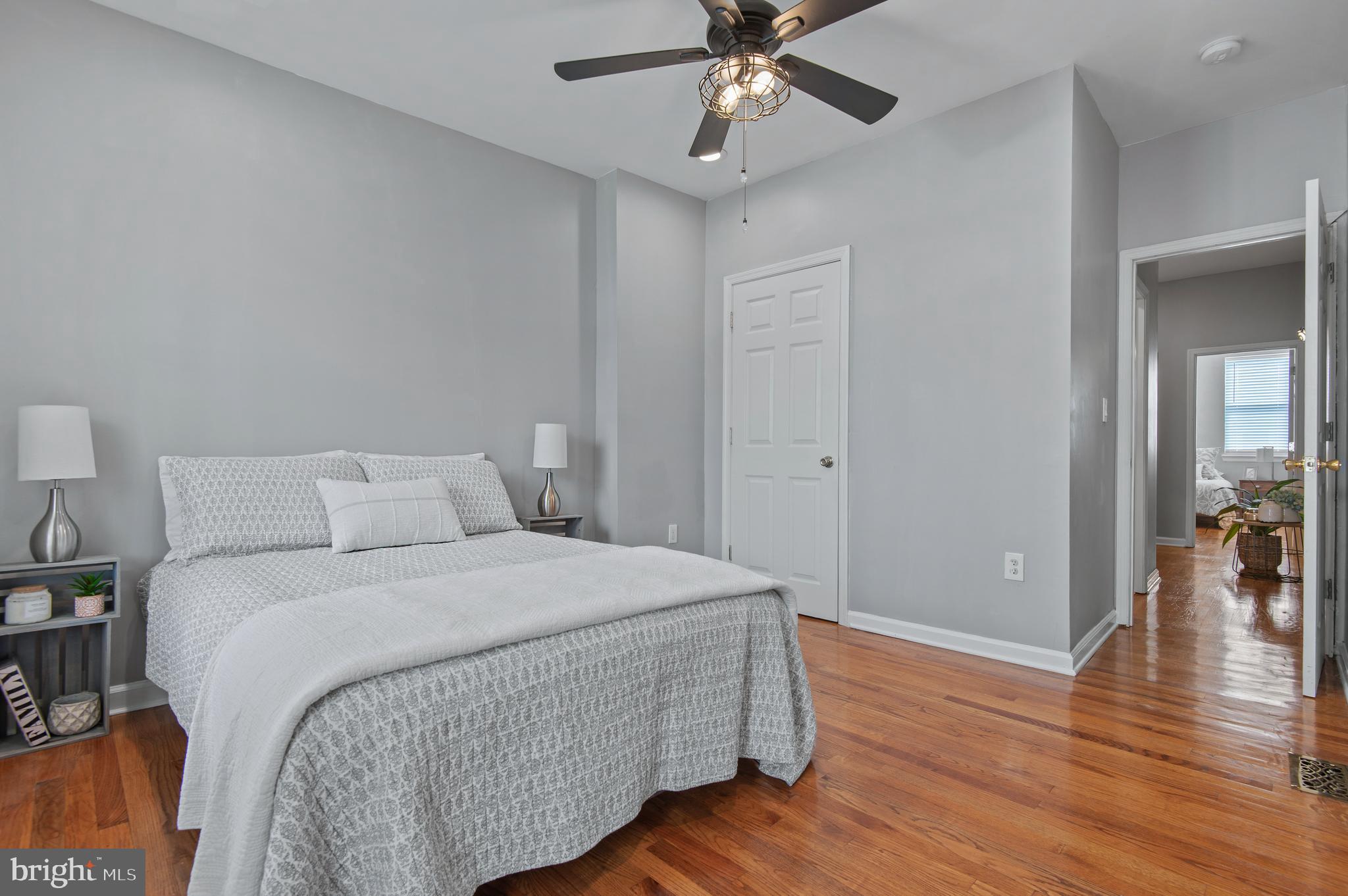 1236 Sargeant Street Baltimore, MD 21223 - Photo 12 of 19 a bedroom with a bed and wooden floor