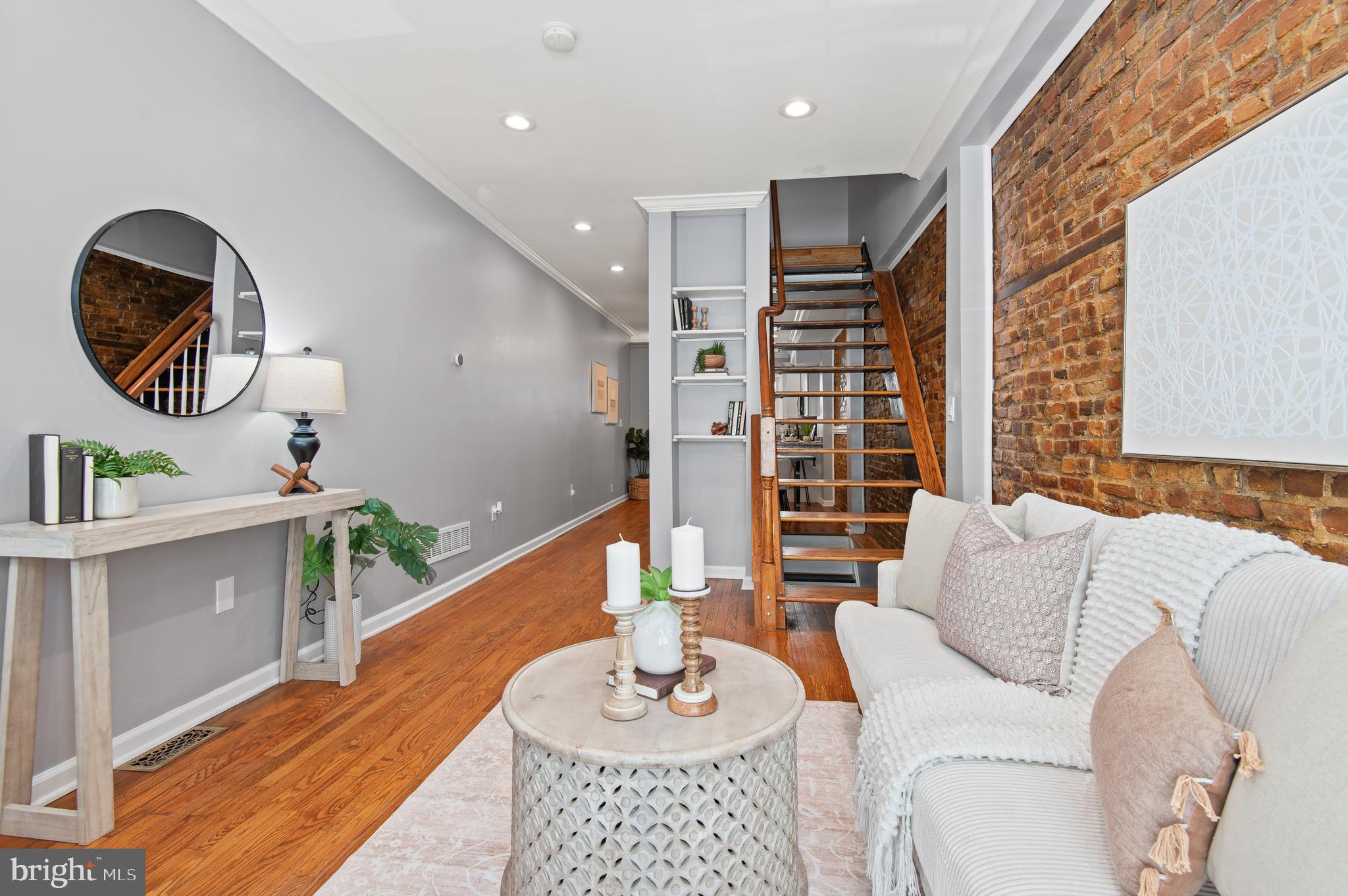 1236 Sargeant Street Baltimore, MD 21223 - Photo 3 of 19 a living room with furniture and a wooden floor