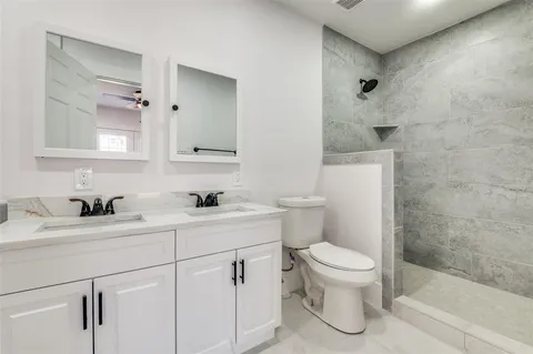 a bathroom with a sink a toilet and a mirror