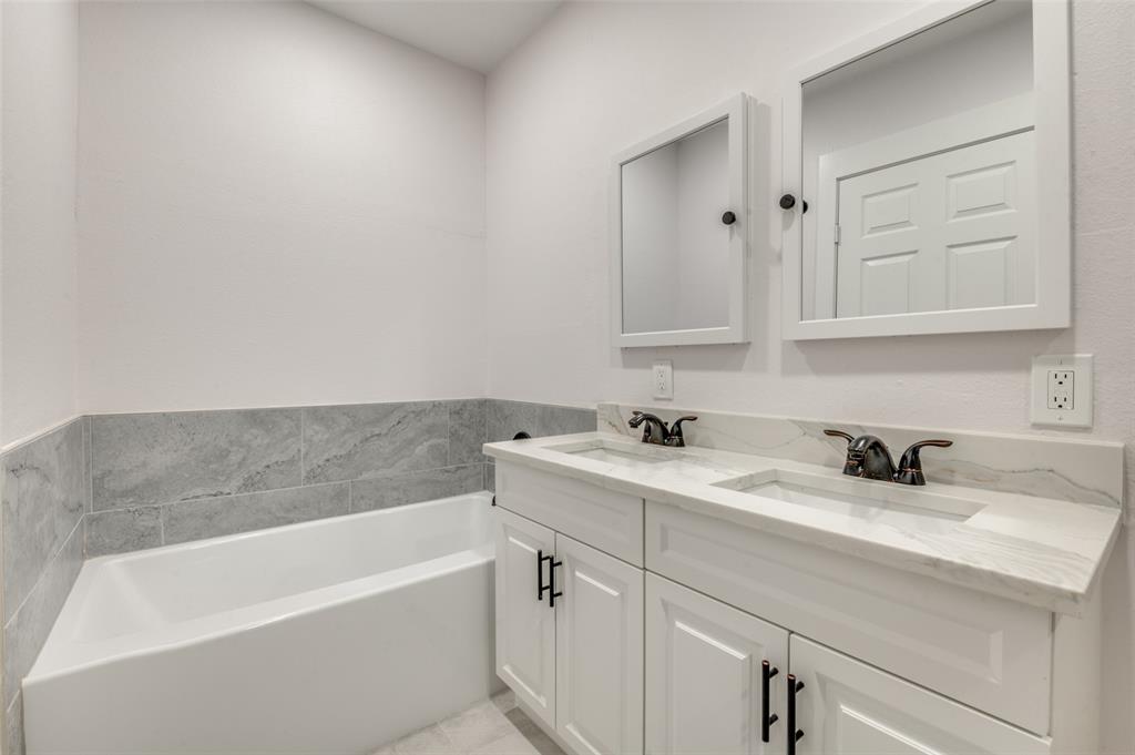 2502 West Lovers Lane Dallas, TX 75235 - Photo 15 of 20 a bathroom with a sink and a bathtub