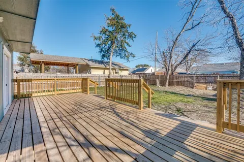 a view of a wooden deck with a yard