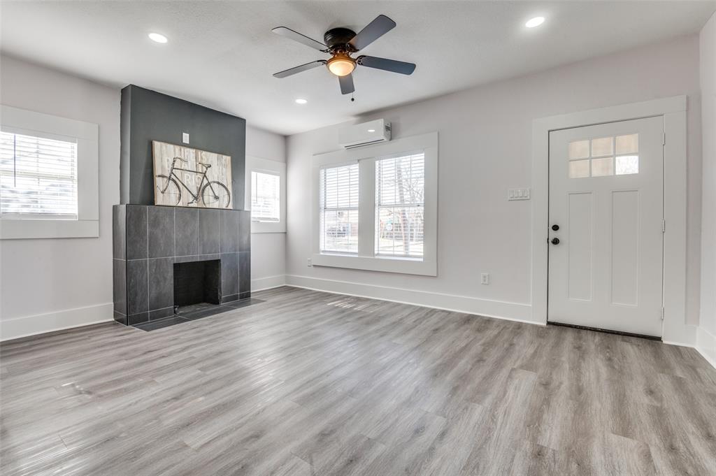 2502 West Lovers Lane Dallas, TX 75235 - Photo 2 of 20 an empty room with windows and a fireplace