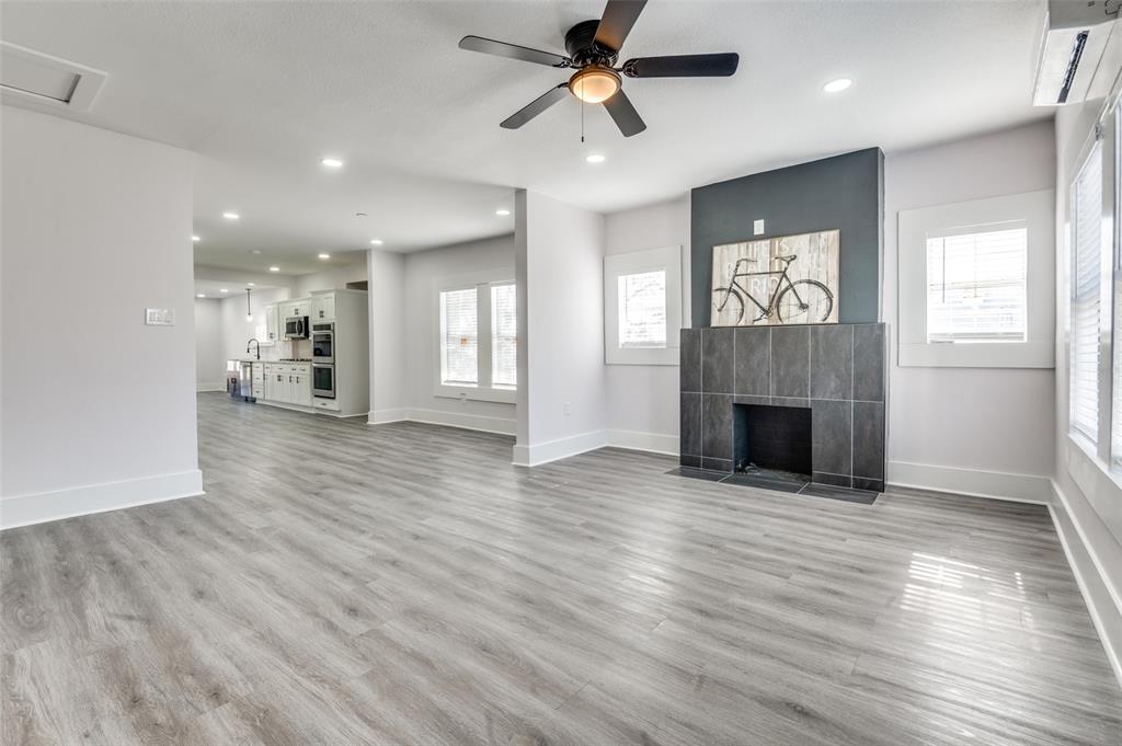 2502 West Lovers Lane Dallas, TX 75235 - Photo 5 of 20 an empty room with wooden floor fireplace and windows