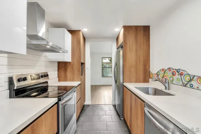 a kitchen with a sink stove and refrigerator