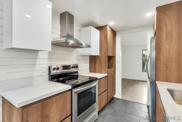 a kitchen with stainless steel appliances a stove and a refrigerator