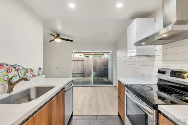 a kitchen that has a sink and a stove