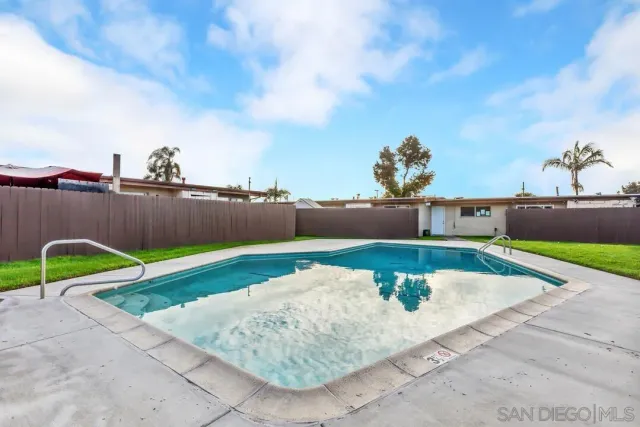 a view of a backyard with a table and chairs