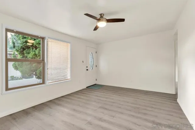 wooden floor in an empty room with a window