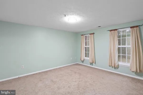 a view of an empty room and a window