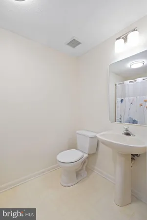 a white toilet sitting next to a bathroom sink