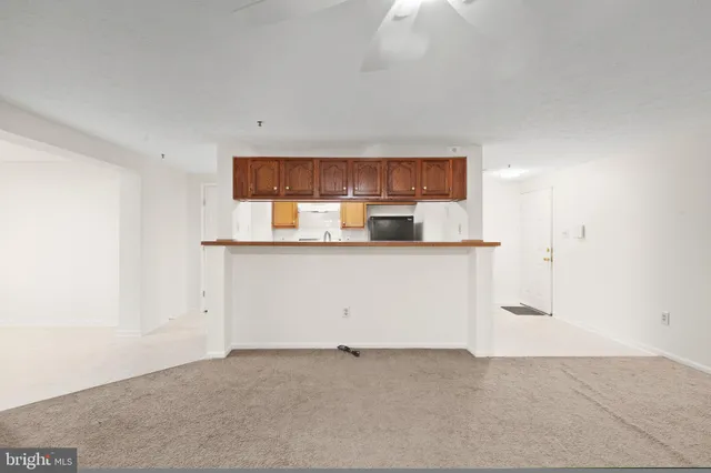 a view of kitchen with stainless steel appliances cabinets and a window