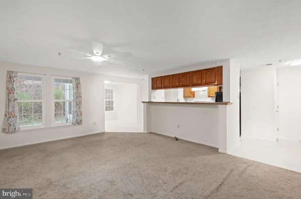 an empty room with windows and entrance