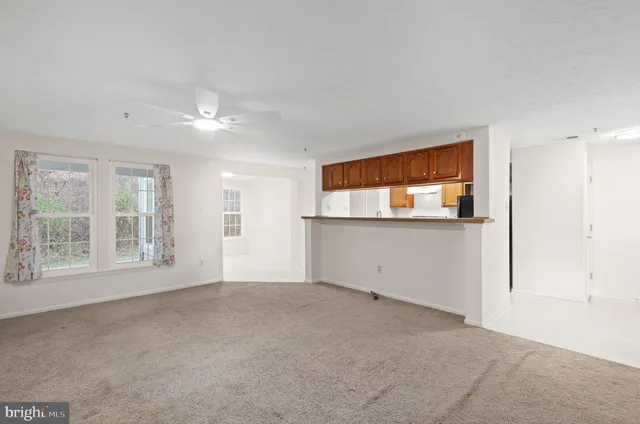 an empty room with windows and entrance