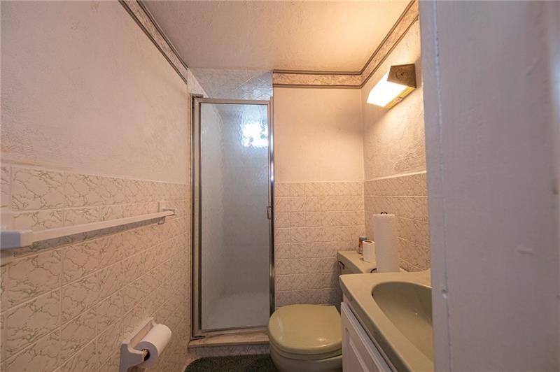 719 Locust Street Greensburg, PA 15601 - Photo 14 of 18 a bathroom with a granite countertop bathtub shower sink mirror and toilet