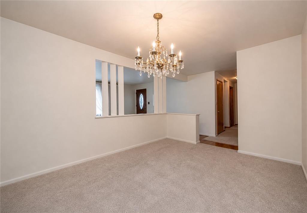 719 Locust Street Greensburg, PA 15601 - Photo 3 of 18 a view of a chandelier in big room with windows and chandelier