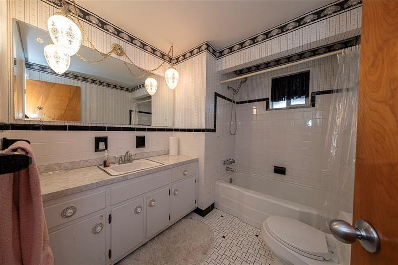 719 Locust Street Greensburg, PA 15601 - Photo 9 of 18 a bathroom with a granite countertop sink toilet and shower