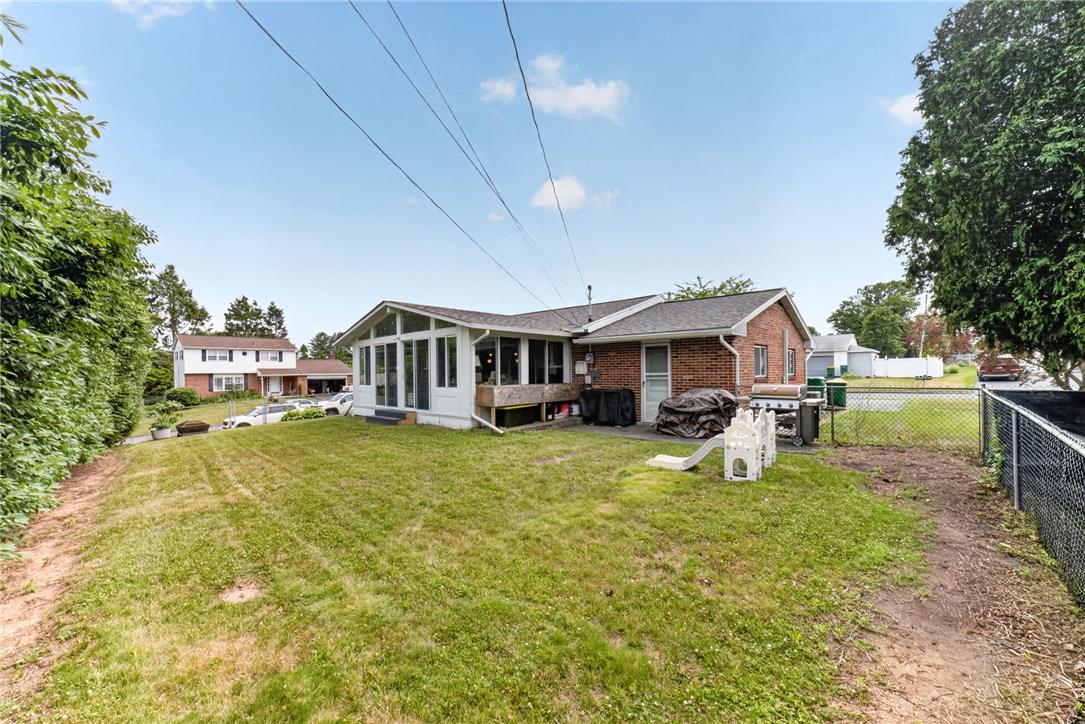 7290 Heather Road Macungie, PA 18062 - Photo 5 of 39 A deep backyard with a sunroom addition and ample space for outdoor enjoyment.