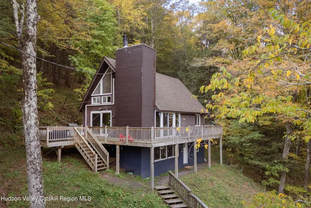 a view of a house with a yard and deck