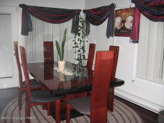 726 Decker Road Bushkill, PA 18324 - Photo 3 of 28 a view of a dining room with furniture and wooden floor