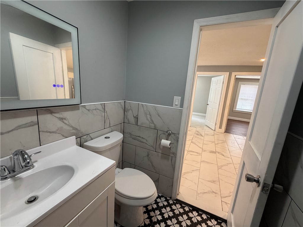 302 Sirrine Street Honea Path, SC 29654 - Photo 15 of 24 A well-appointed bathroom features a modern vanity and intricate floor tiling.