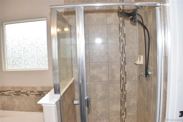 a bathroom with a shower and a tub