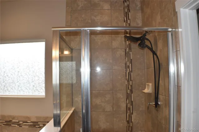 a bathroom with a glass shower door