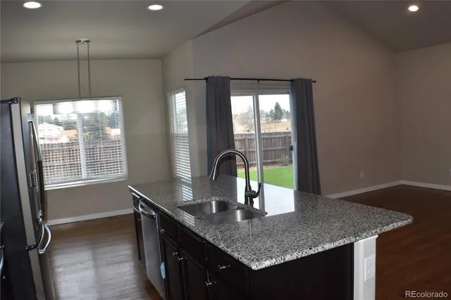 a kitchen with a sink a counter and window