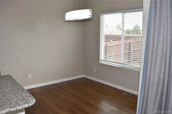 a view of a room with wooden floor and a window
