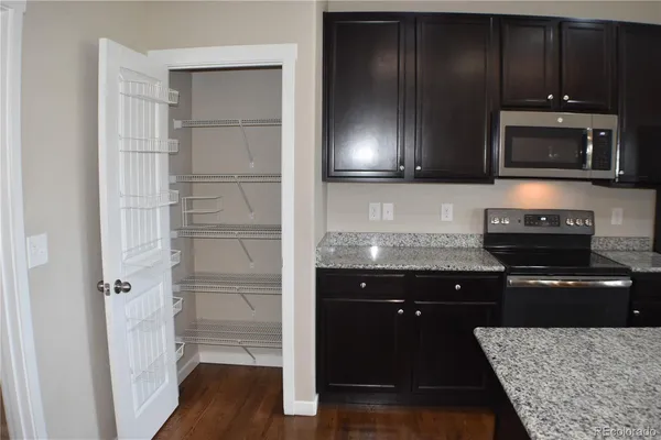 a kitchen with a refrigerator and a stove top oven