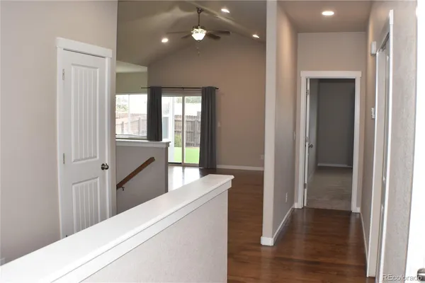 a bathroom with a granite countertop bathtub sink vanity mirror and toilet