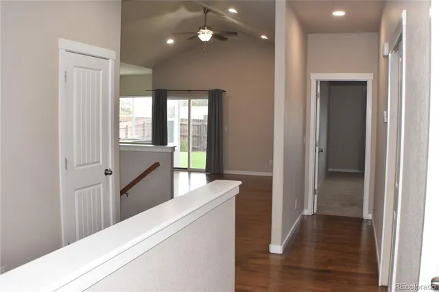 a bathroom with a granite countertop bathtub sink vanity mirror and toilet